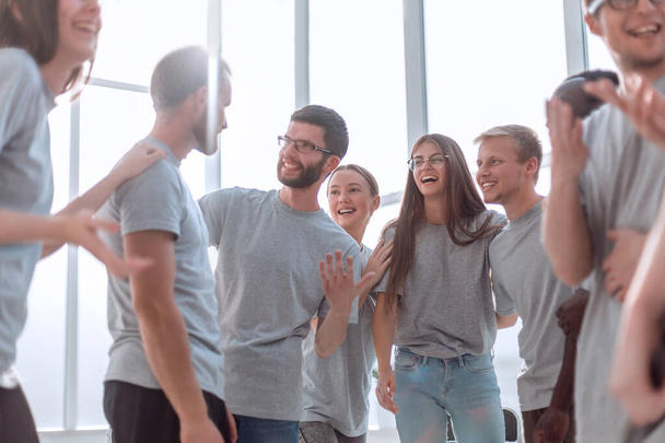 group of diverse young men in grey t-shirts standing together - Фото, изображение
