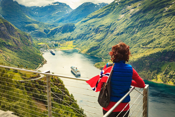 Tourist over Geirangerfjord with norwegian flag - Фото, зображення