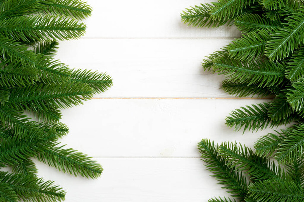 Top view of Christmas background made of fir tree branches. New year concept with copy space on wooden background - Fotoğraf, Görsel