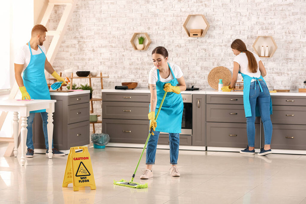 Team of janitors cleaning kitchen - 写真・画像