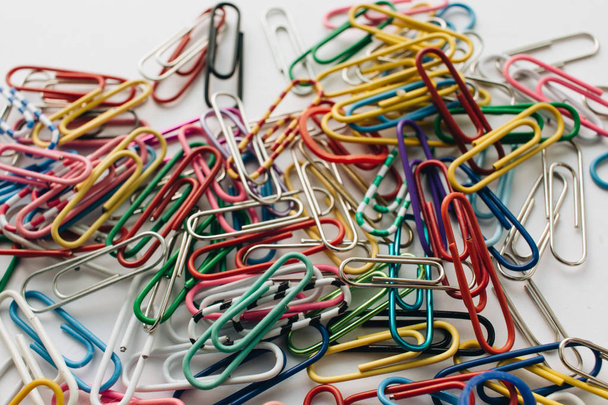 pile of colorful paper clips on white background, flat lay - Photo, image