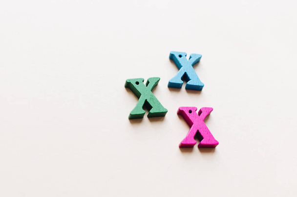colorful small scattered wooden X letters  - Foto, Bild
