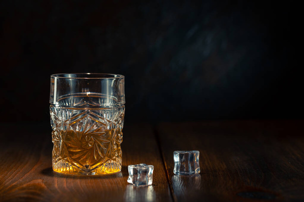 Whiskey in glass with ice - 写真・画像