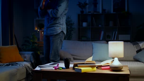 Young man doing brainstorm at night at home - Кадри, відео