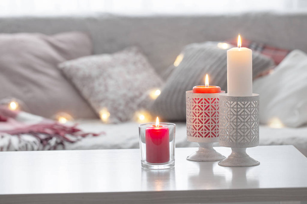 Composition of candles on  white table against the background of - Φωτογραφία, εικόνα