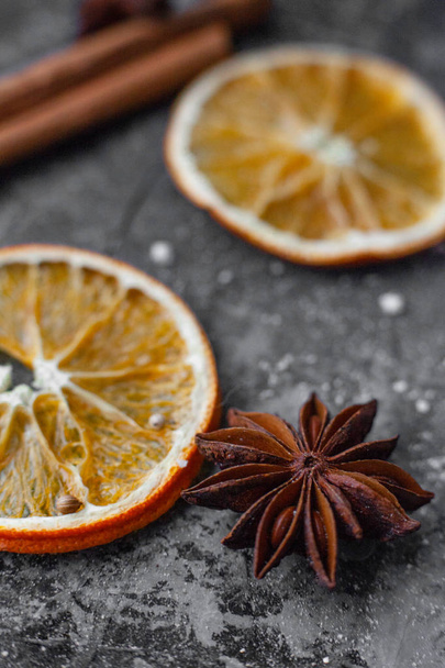 oranges and cinnamon sticks on a dark background - Foto, Imagen