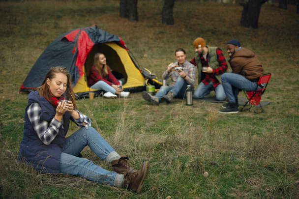 Group of friends on a camping or hiking trip in autumn day - Фото, зображення