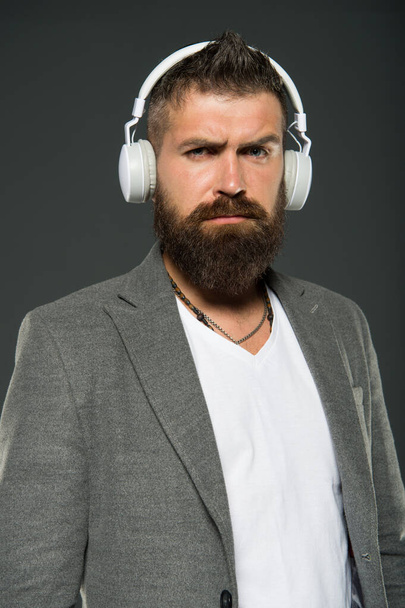 Lifestyle music fan. Man listening music wireless headphones. Hipster use headphones gadget. Inspiring song. Music library. Bearded guy enjoy music. Audio book. Application for listening books - Foto, imagen