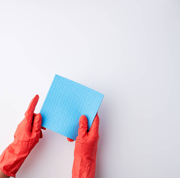 blue square absorbent sponges in their hands wearing red rubber  - Fotografie, Obrázek