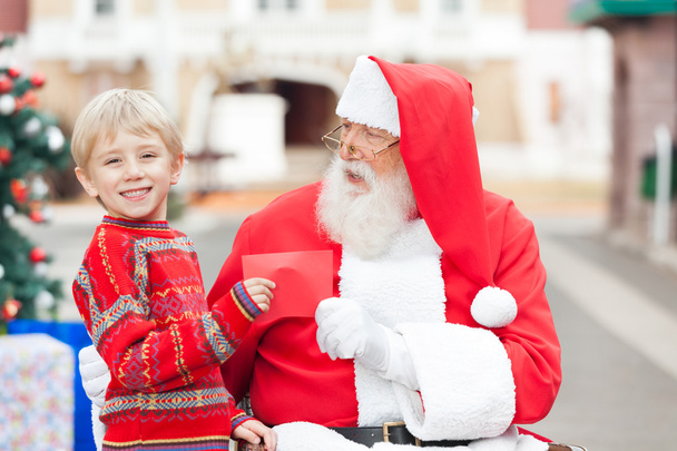 Happy Boy Giving Letter To Santa Claus - Fotografie, Obrázek