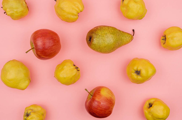 Autumn pears, apples, quince on a pink background. - Photo, Image