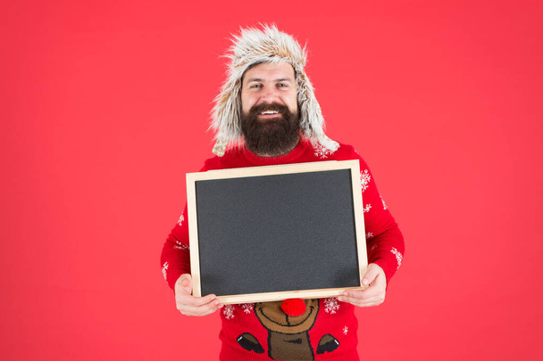 Ad man. Happy man hold empty blackboard. Bearded man in winter wear. Hipster with mustache smile. Brutal man with advertising board, copy space - Fotografie, Obrázek