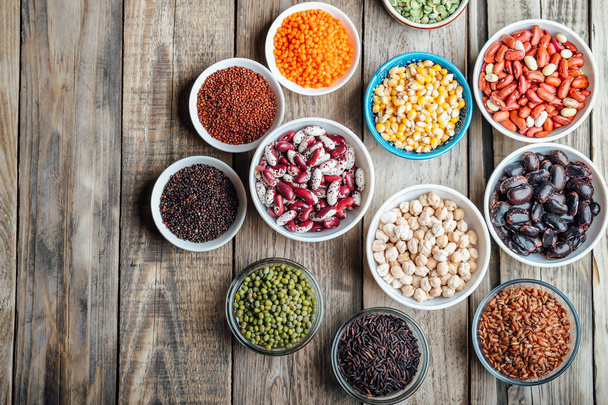 Super food. Seeds and beans assortment on a rustic background copy space. Vegetarians. Top view  - Photo, Image