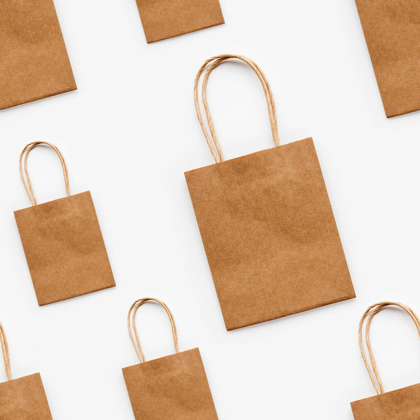 Photo seamless pattern with craft paper shopping bags. Zero waste lifestyle. Copy space. - 写真・画像