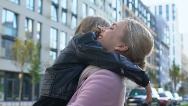 Glad woman hugging female child outdoors, mother unconditional love, parenthood - Filmmaterial, Video