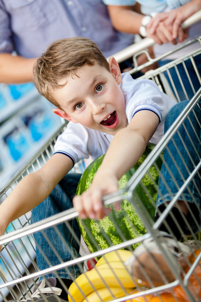 Little boy sits in the cart with watermelon - Fotoğraf, Görsel