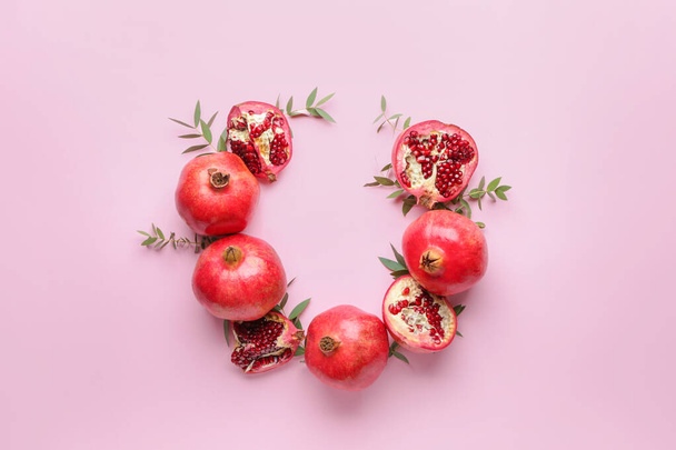 Composition with ripe juicy pomegranates on color background - Photo, Image