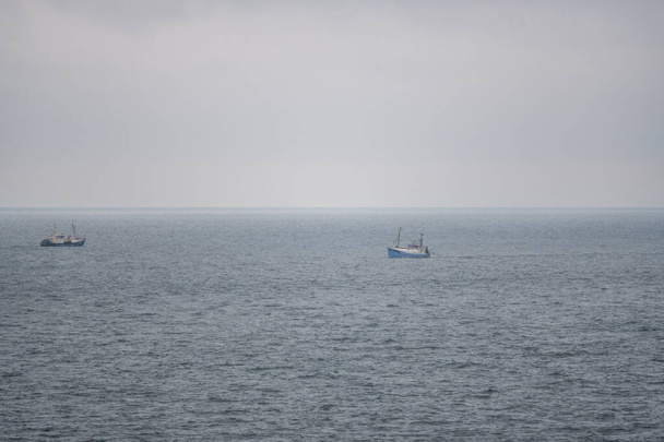 Fishing boats fishing  for delicious fish on the North Sea - Foto, afbeelding
