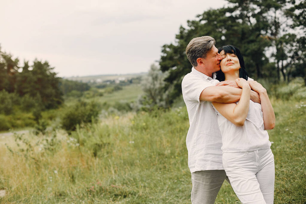 Beautiful adult couple spend time in a summer field - Foto, Imagem