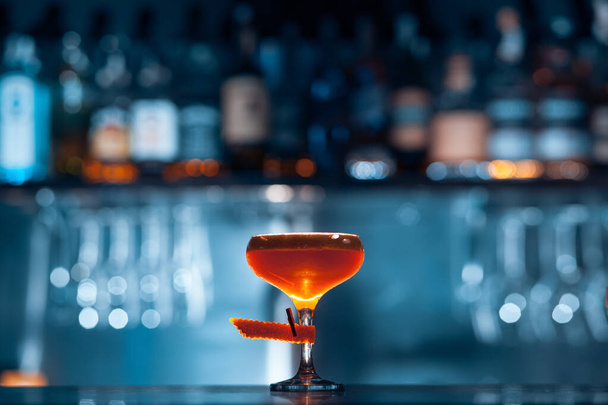 glass of fresh orange cocktail on blue background - Fotoğraf, Görsel