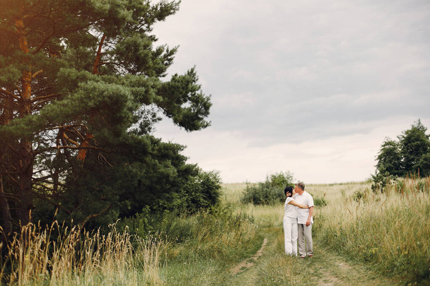 Beautiful adult couple spend time in a summer field - Photo, Image