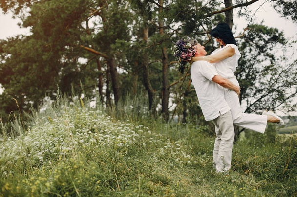 Beautiful adult couple spend time in a summer field - Foto, imagen