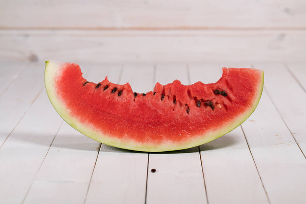 bitten slice of watermelon on a white background - Photo, Image