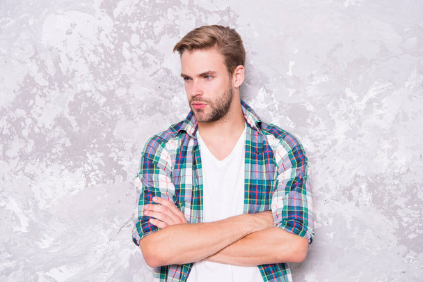 good man hard to find. mens sensuality. sexy guy casual style. macho man grunge wall. male fashion summer trend. confident student checkered shirt. unshaven man care beard. barbershop concept - Foto, afbeelding