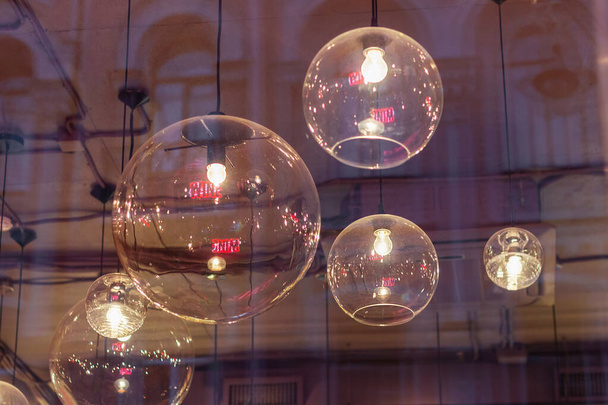 transparent round lampshades with incandescent bulbs. design illumination - Foto, Imagen