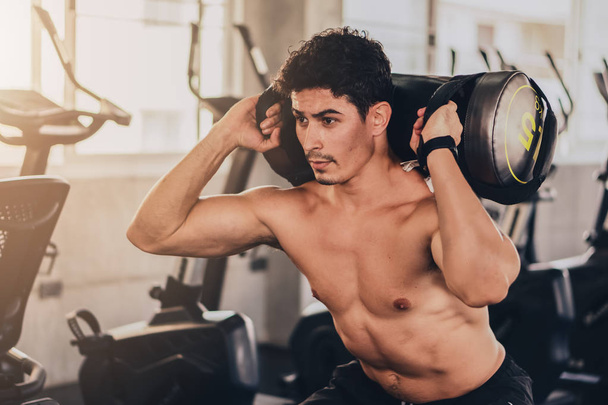 sport background of caucasian young man having workout in gym ce - 写真・画像
