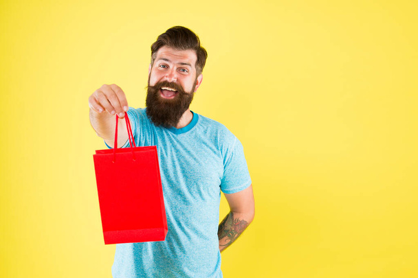 for you. Happy hipster hold paper bag. Man with purchase. Buy product. bearded man go shopping. Shopping concept. Shop store boutique. mature male with fashion purchase. small present. copy space - Fotografie, Obrázek