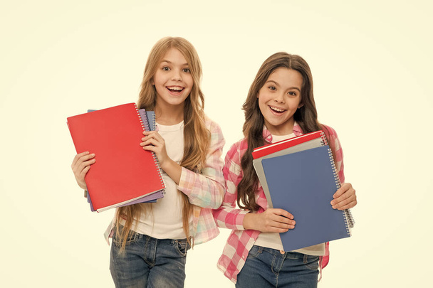 Language courses for youth. Girls with school textbooks white background. School concept. We love study. Pupils carrying textbooks to school classes. Studying is fun. Buy book for extra school course - Фото, изображение