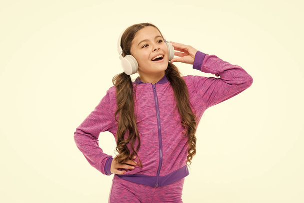 Vocal music lover. Athletic kid training her vocal after workout. Small child doing vocal on song. Little girl listening and singing vocal melody - Photo, image