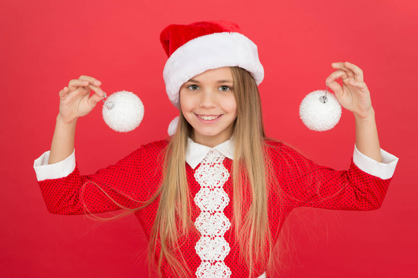 Add some decorations. Christmas decorating ideas. Child Santa Claus costume hold christmas balls. Universal decorations. Christmas decor. Winter holidays. Playful mood. Snowball concept. Happy kid - Zdjęcie, obraz
