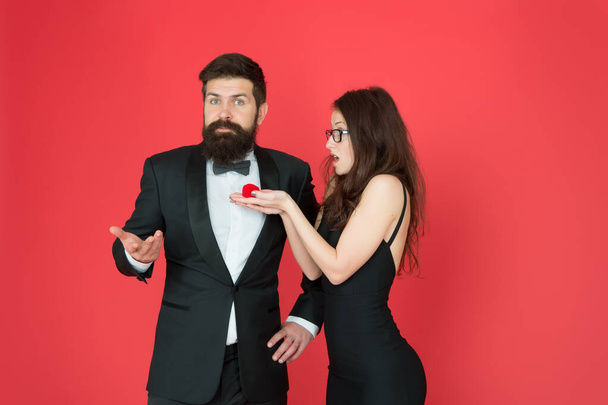 Surprising valentines gift. Sexy girl give engagement gift ring to bearded man. Couple in love. Gift surprise. Love gift. Marriage proposal. Wedding anniversary - 写真・画像