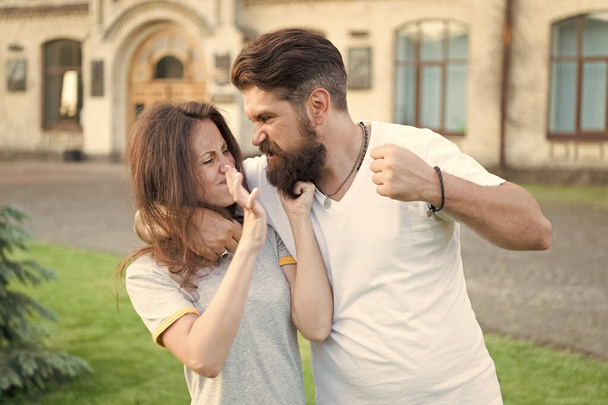 Angry hipster and pretty woman . Relations problem. Family crisis concept. Stop violence social movement. Self defense. Violence and aggression. Family rules. Couple suffer violence against woman - Fotoğraf, Görsel