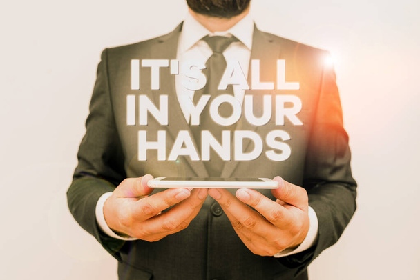Text sign showing It S All In Your Hands. Conceptual photo we Hold the Rein of our Destiny and Fate Male human wear formal work suit hold smart hi tech smartphone use hands. - Photo, Image