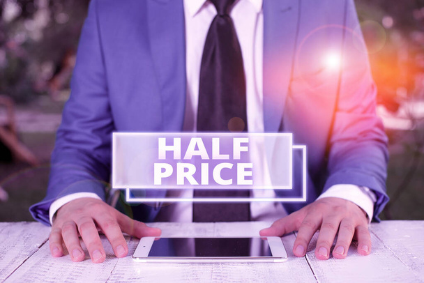 Writing note showing Half Price. Business photo showcasing half the usual price at which something is offered for sale Businessman in blue suite with a tie holds lap top in hands. - Photo, Image