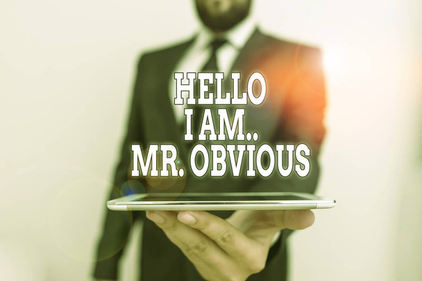 Word writing text Hello I Am Mrobvious. Business concept for introducing yourself as pouplar or famous demonstrating Male human wear formal work suit hold smart hi tech smartphone use one hand. - Fotoğraf, Görsel