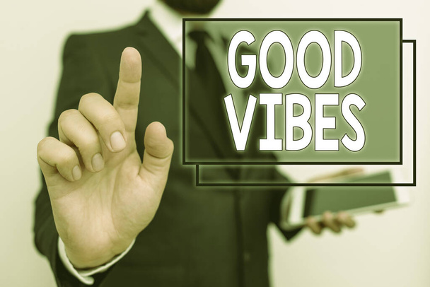Conceptual hand writing showing Good Vibes. Business photo text slang phrase for the positive feelings given off by a demonstrating Male human wear formal work suit hold hi tech smartphone use hand. - Photo, Image