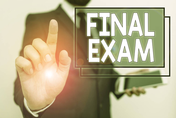 Conceptual hand writing showing Final Exam. Business photo text test given to student at the end of a course of study or training Male human wear formal work suit hold hi tech smartphone use hand. - Photo, Image