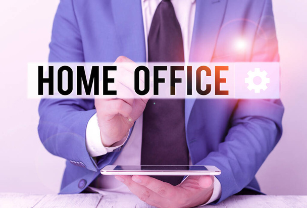 Writing note showing Home Office. Business photo showcasing space designated in a demonstrating s is residence for official business Businessman pointing with pen in empty copy space. - Photo, Image