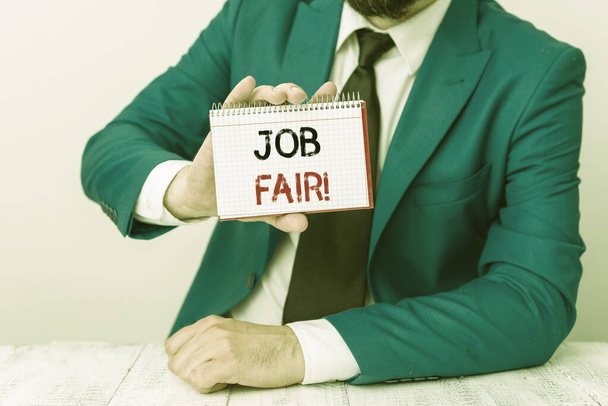 Text sign showing Job Fair. Conceptual photo event where employers offer information about their companies Man holds empty paper with copy space in front of him Copy Space. - Photo, Image