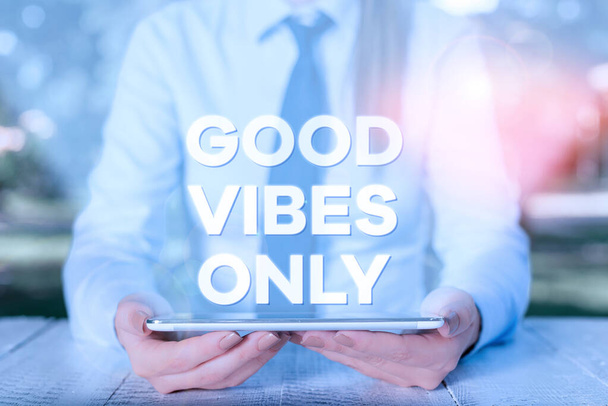 Handwriting text writing Good Vibes Only. Concept meaning Just positive emotions feelings No negative energies Female business person sitting by table and holding mobile phone. - 写真・画像