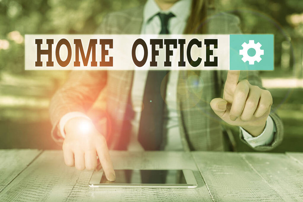 Handwriting text writing Home Office. Concept meaning space designated in a demonstrating s is residence for official business Female business person sitting by table holding mobile phone. - Photo, Image