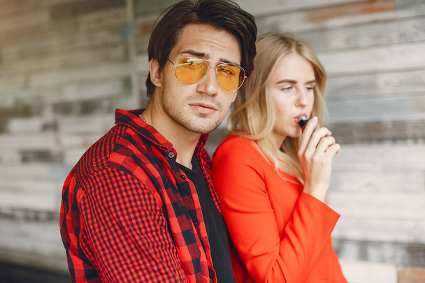 Stylish young couple with vape in a city - Фото, зображення