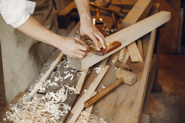 Handsome carpenter working with a wood - Fotografie, Obrázek