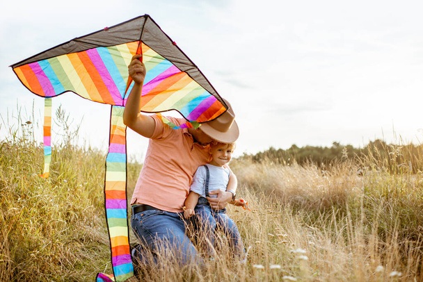 Father and son with kite on the field - Photo, Image