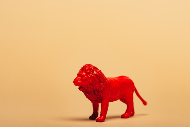 Red toy lion on yellow background, animal welfare concept - Photo, Image
