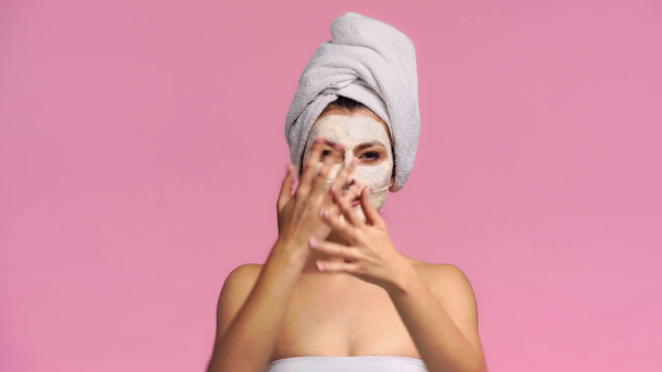 happy girl applying clay mask isolated on pink  - Footage, Video